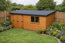 Timber garden shed with a freshly installed smooth dark grey EPDM rubber flat roof, membrane neatly dressed over the roof edges, in a UK garden