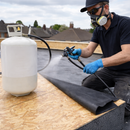 Sprayable EPDM contact bonding adhesive being applied to flat roof membrane - rubber roofing adhesive UK