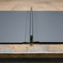 Close-up of interlocked standing seam metal roofing panels showing seam profile