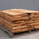 Bundle of western red cedar roof shingles showing natural wood grain and random widths