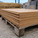 Stack of rigid wood fibre insulation boards on a pallet showing tongue and groove edge profile