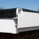 White uPVC roof edge trim installed on a flat roof EPDM membrane edge